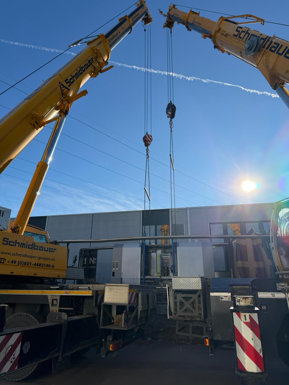 Synchronized dual-crane lift of a heavy CNC machine inside the facility