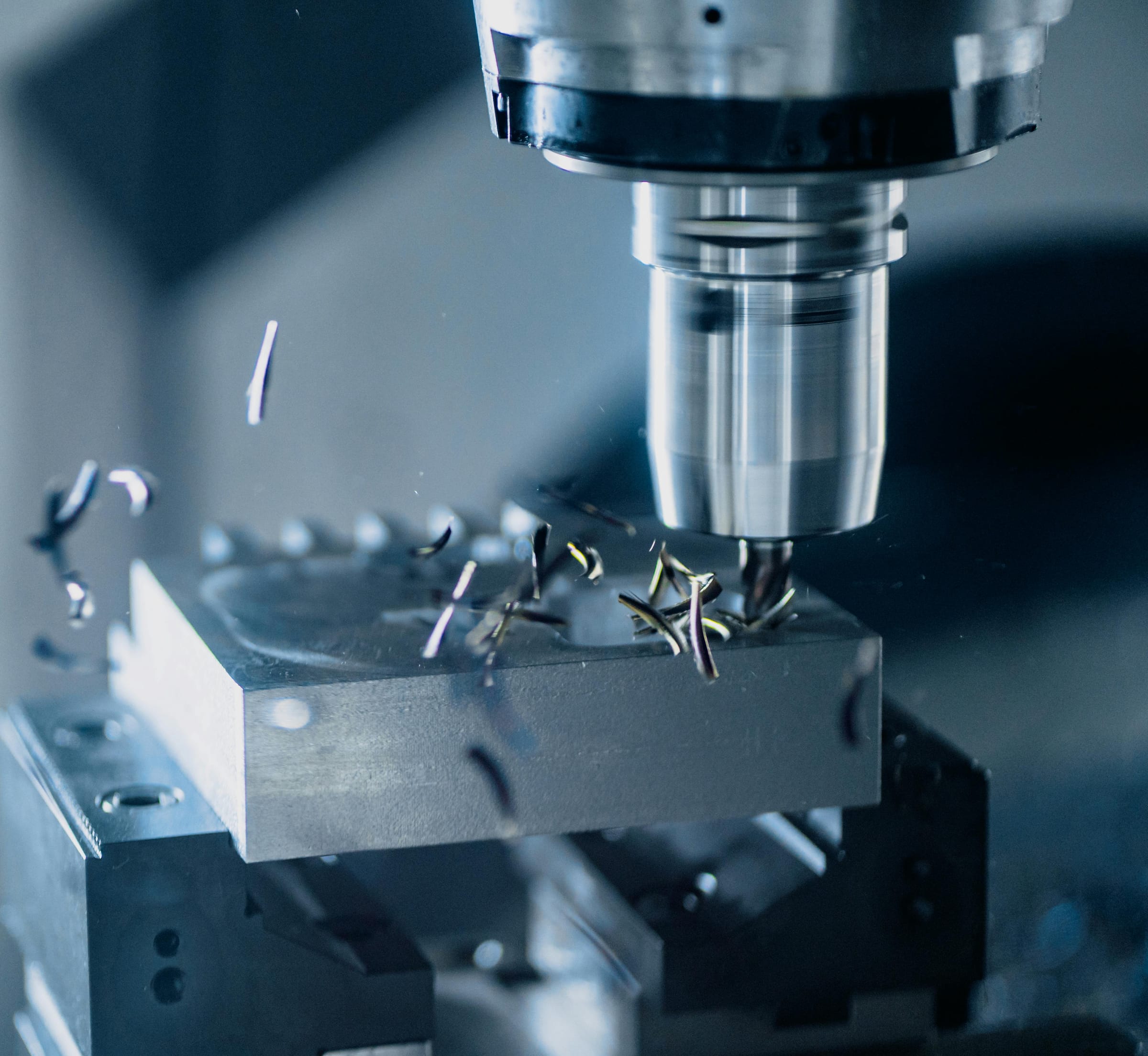 Milling cutter in action — chip removal on a CNC milling machine, close-up