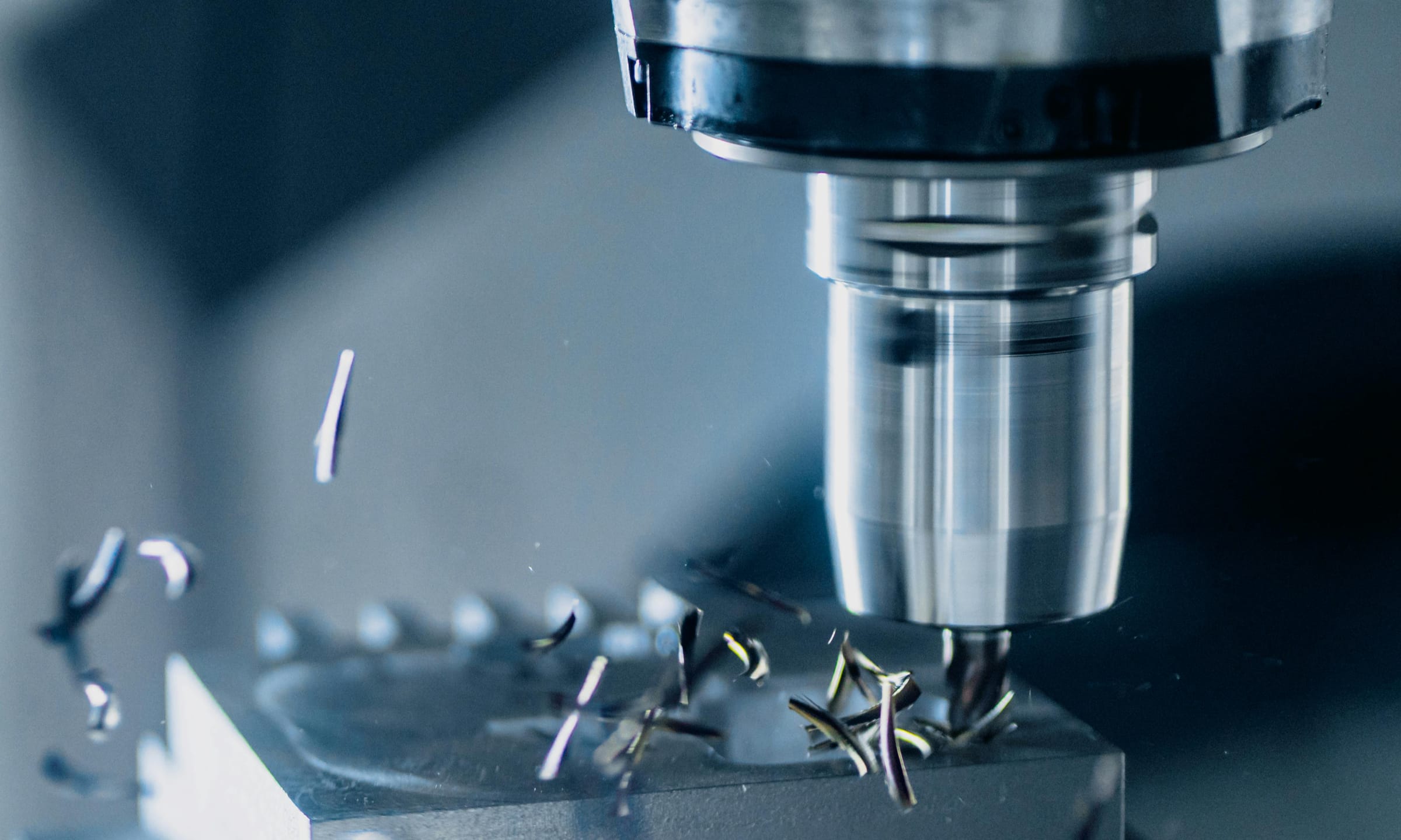 CNC milling in progress — metal chip removal close-up