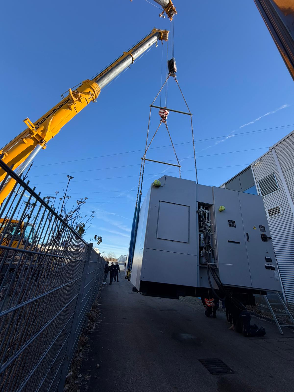 Crane lift of a heavy machining center — being prepared for transport