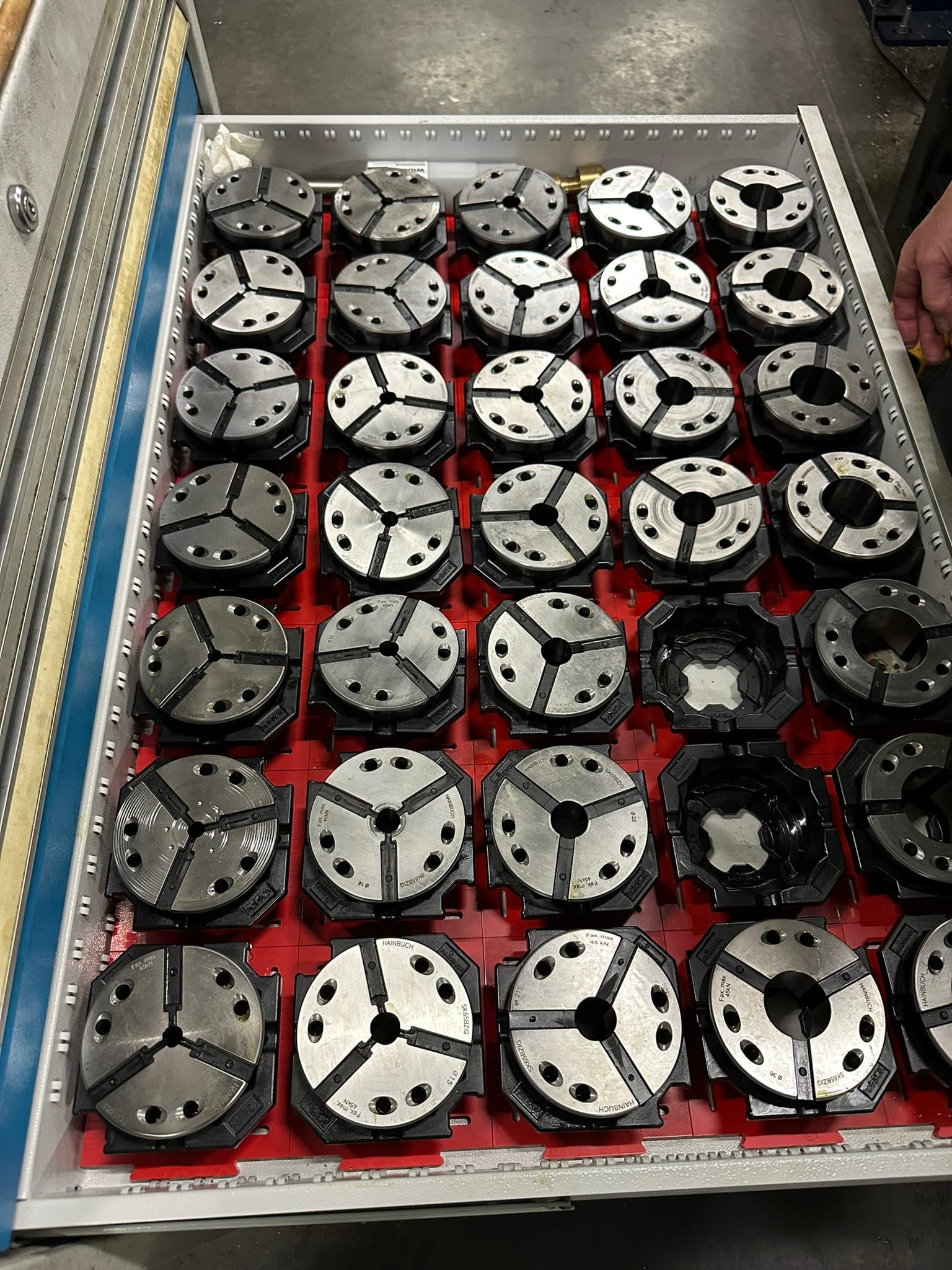 Collet chucks for CNC lathes stored in a tooling drawer