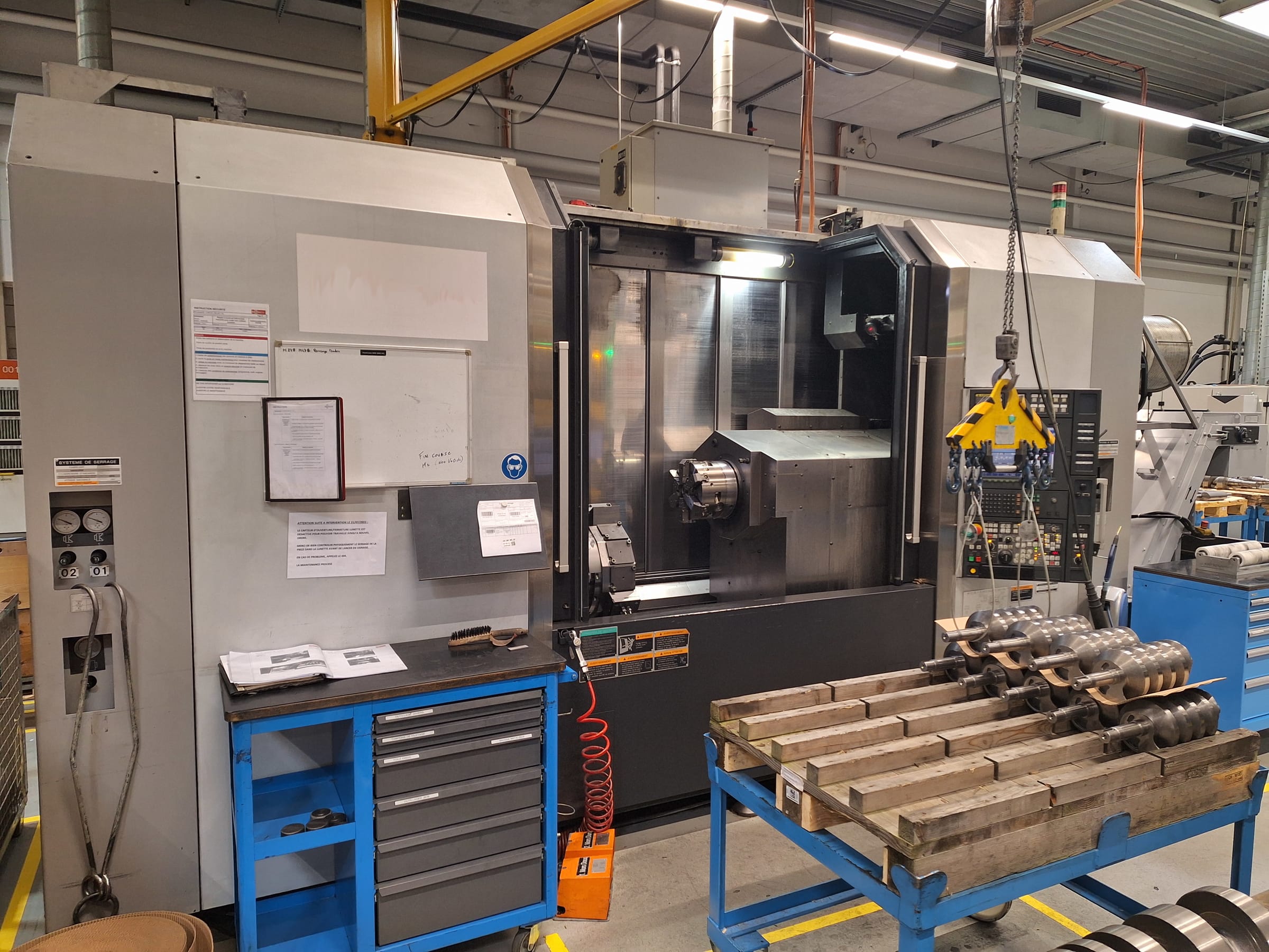 Overview shot of a CNC machine shop floor with several machining centers